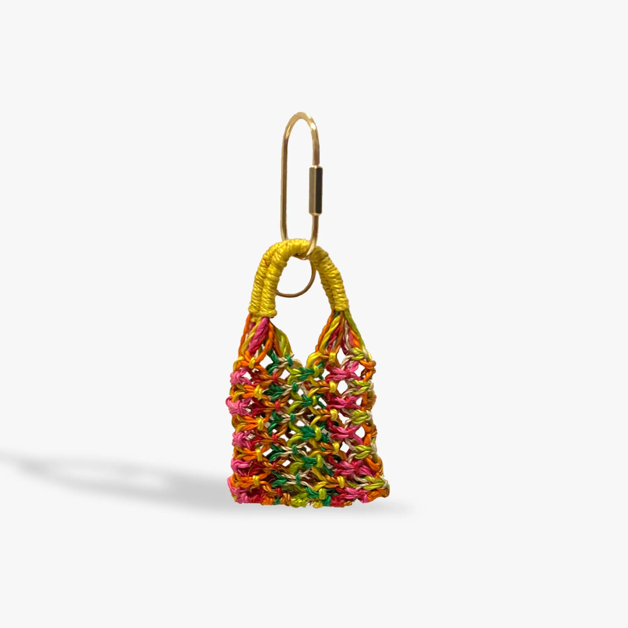 Colorful woven bag charm on a white background