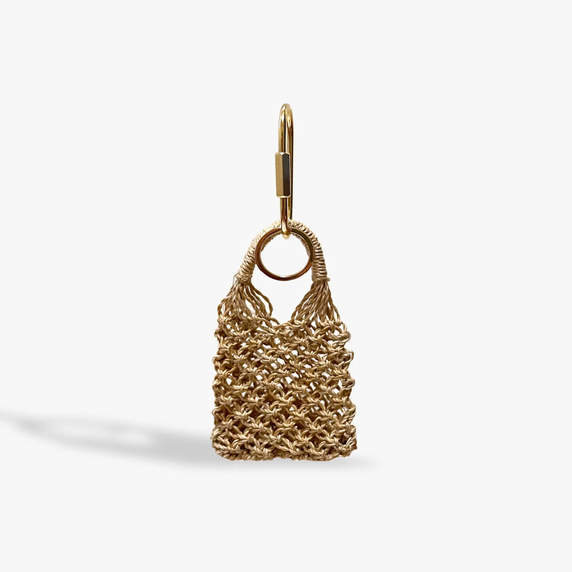 Gold mesh bag charm on a white background