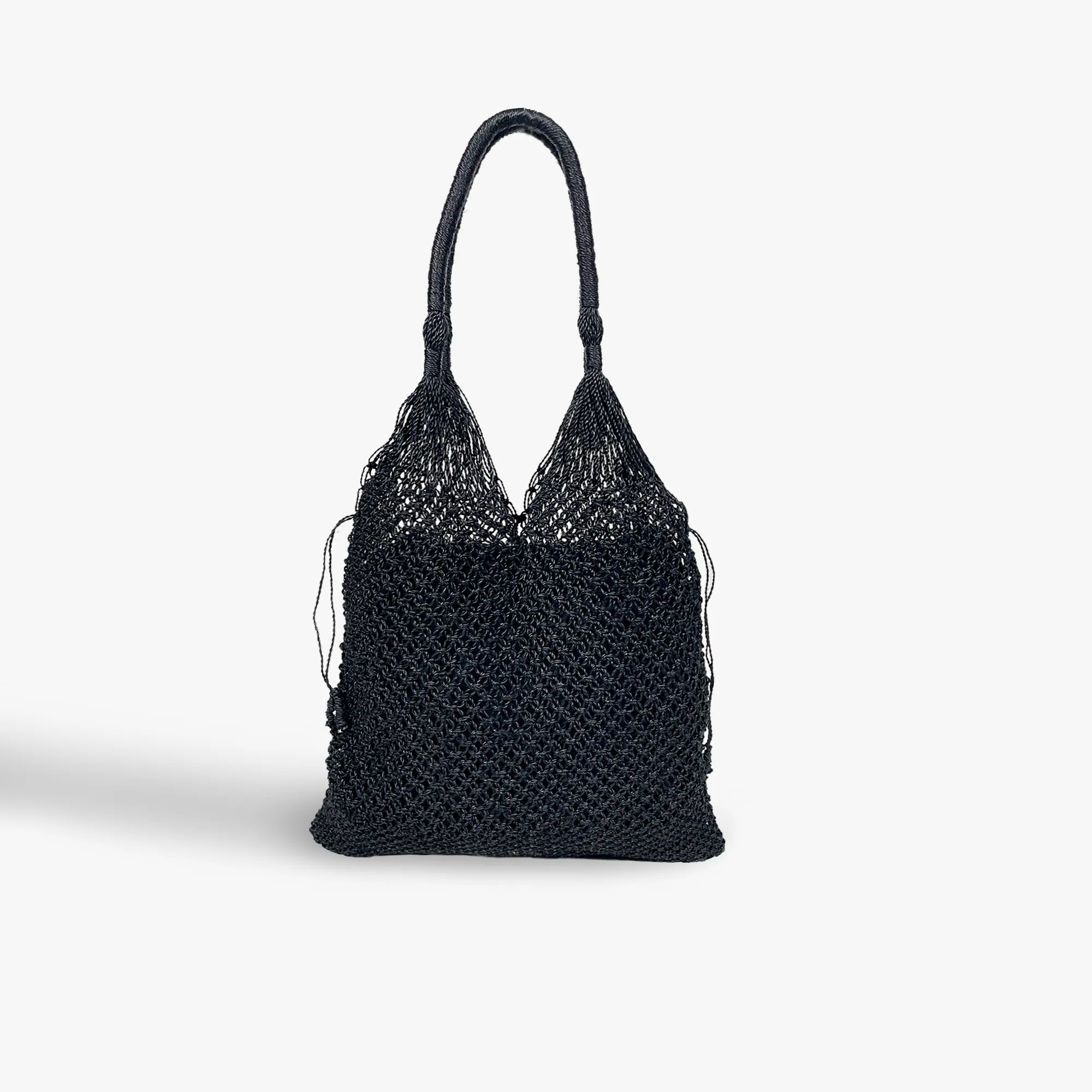 Black woven handbag on a white background