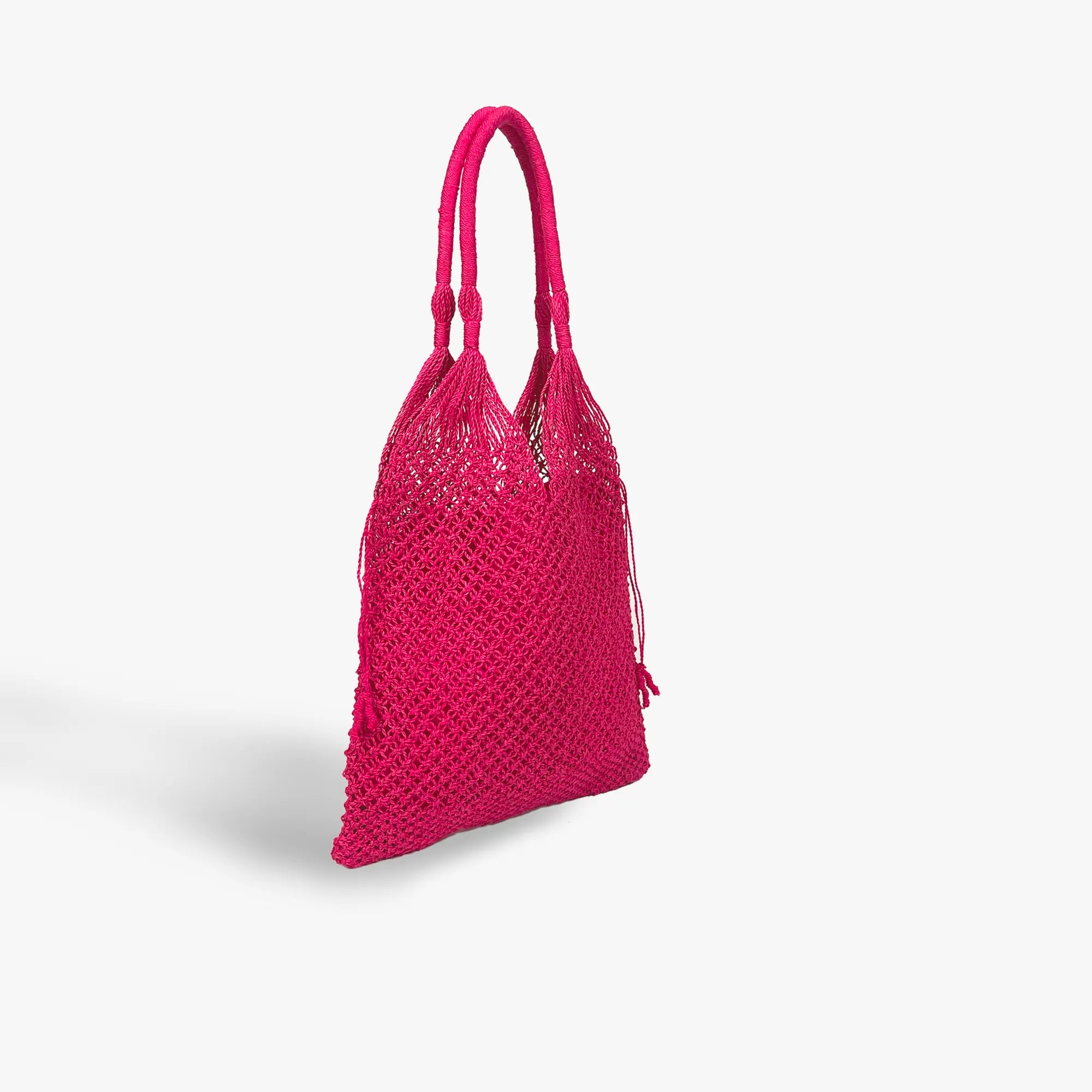Pink woven handbag on a light gray background