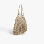 Textured tote bag with tassels on a light gray background