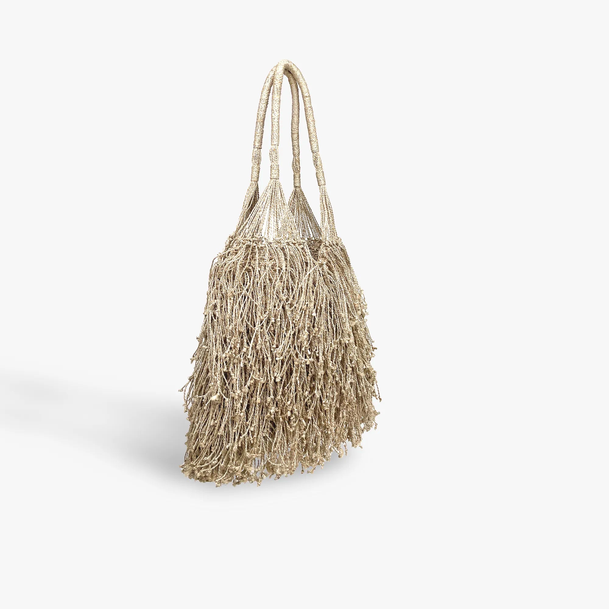 Textured tote bag with tassels on a light gray background